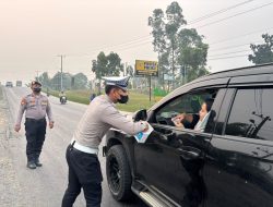 Peduli Kesehatan Warga, Polres Kuansing Bagikan Masker di Tengah Udara Berasap